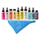 Set of spray bottles with various labels and a blue towel on a white background