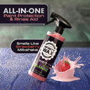 Infinity Wax spray bottle with strawberry milkshake flavor on a wet surface background